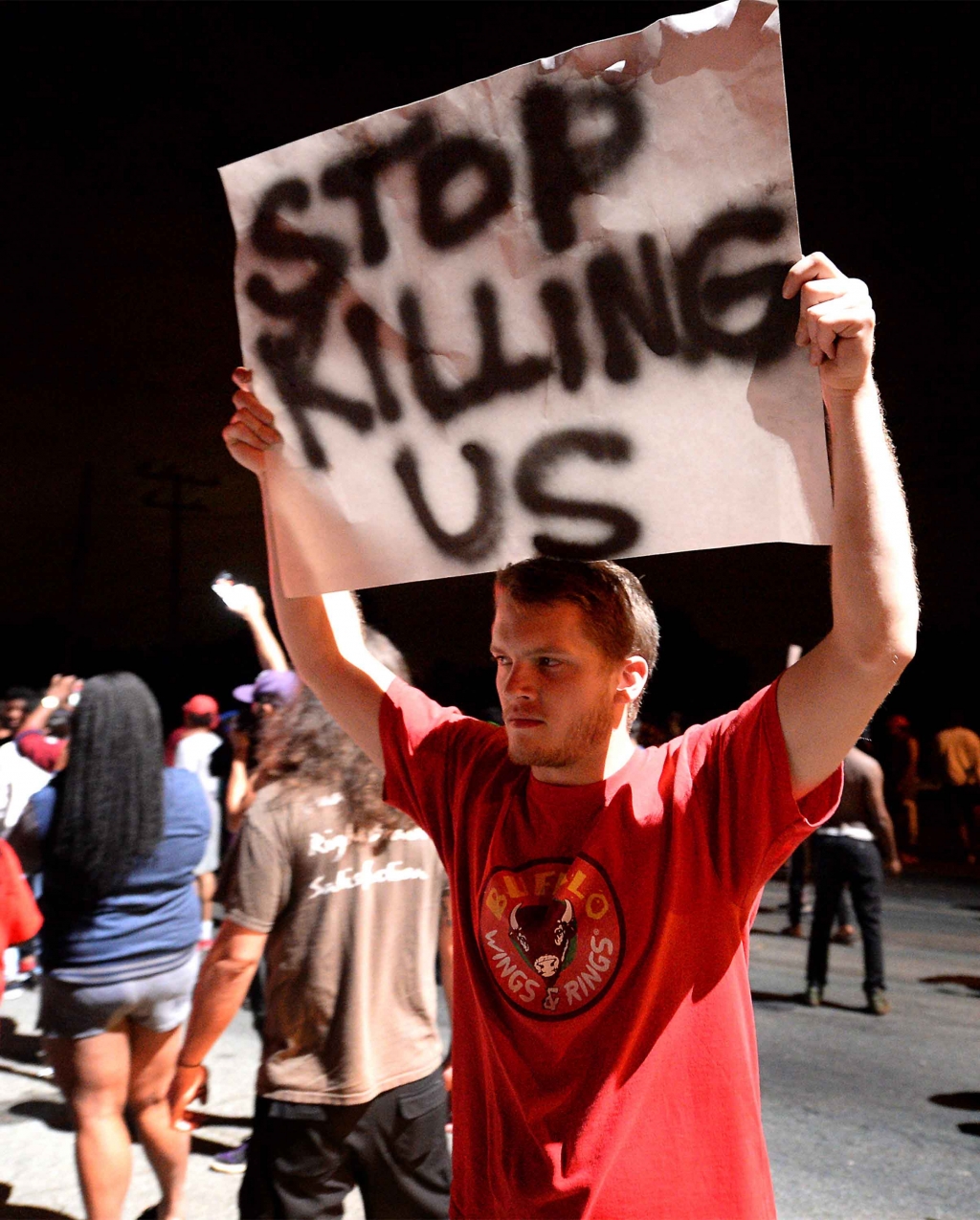 A protestor carries a sign along Old Concord Rd. on Tuesday night Sept. 20 2016 in Charlotte N.C