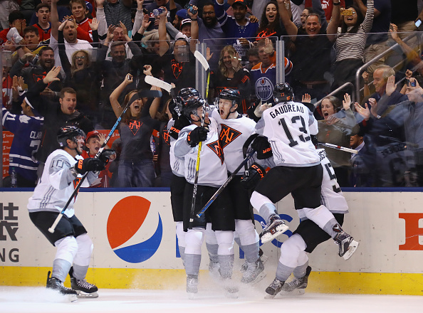 Team North America players mob Nathan Mac Kinnon after his overtime winner against Sweden