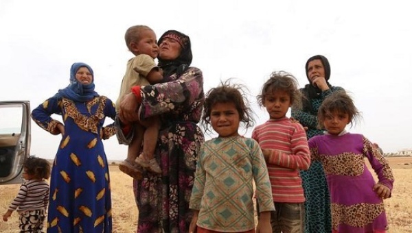 A family that fled from Hama stand in a field in southern rural Manbij where Syria Democratic Forces have taken control in Aleppo Governorate Syria