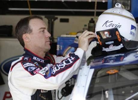 Kevin Harvick who will start at the front in Sunday’s Sprint Cup race adjusted his helmet before practice Saturday