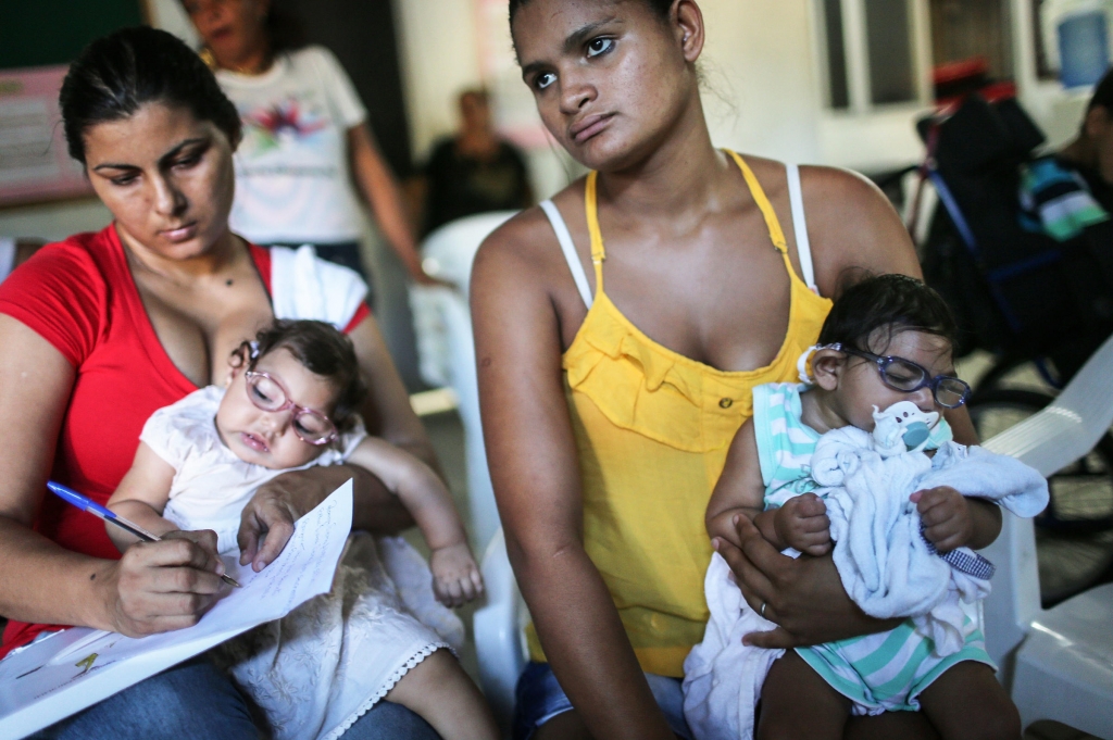 Infants born with microcephaly are held by mothers at a meeting for mothers of children with special needs in Recife Brazil