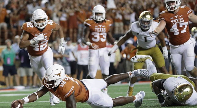 AUSTIN TX- SEPTEMBER 04 Tyrone Swoopes #18 of the Texas Longhorns dives for the game-winning touchdown in the second overtime against the Notre Dame Fighting Irish at Darrell K. Royal Texas Memorial Stadium