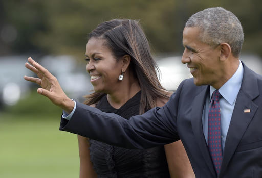 President Barack Obama with first lady Michelle Obama waves as they walk from Marine One on the South Lawn of the White House in Washington Wednesday Sept. 21 2016. The Obama's were returning from New York where the president addressed the Unite