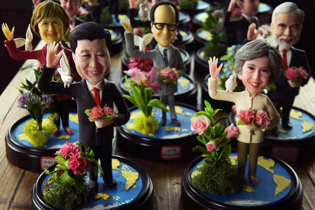 The Chinese artist Wu Xiaoli has produced clay models of world leaders attending the G20 summit including Theresa May rightAP