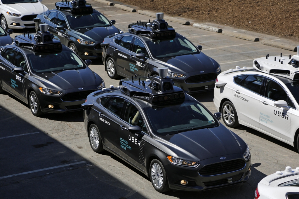 A group of self-driving Uber vehicles are lined up to take journalists on rides during a media preview at the company's Advanced Technologies Center in Pittsburgh earlier this month