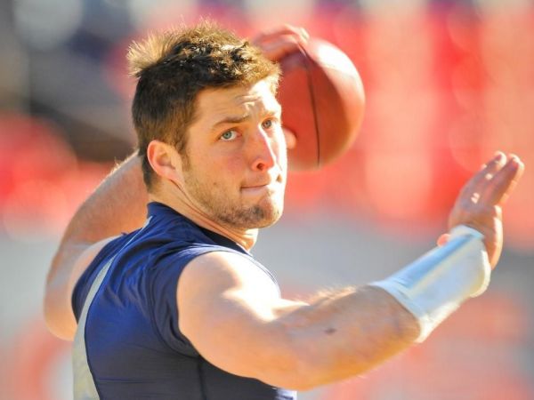 NEW YORK NY- APRIL 15 New York Jet quarterback Tim Tebow and Miami Heat's Dwyane Wade watch on during the game between the Los Angeles Angels of Anaheim and the New York Yankees at Yankee Stadium