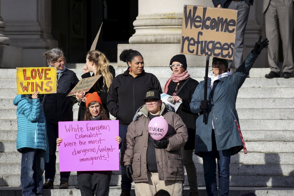 Pro-refugee counter-protesters gather during another group's protest against the United States acceptance of Syrian refugees at the Washington State capitol in Olympia Washington