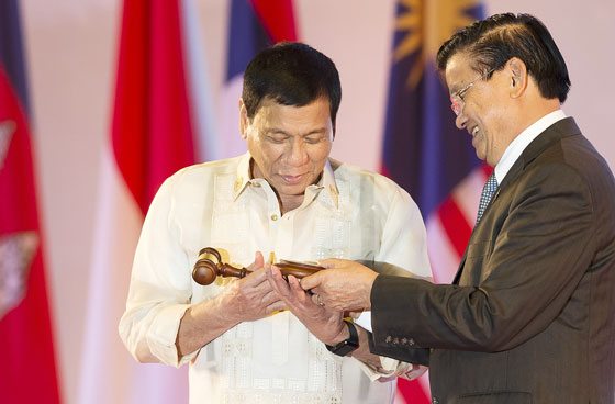 ASEAN CHAIRMAN President Rodrigo Duterte accepts the gavel from Prime Minister Thongsing Thammavong of Laos during the closing ceremony of the Association of Southeast Asian Nations. Laos handed the Asean chairmanship to the Philipp