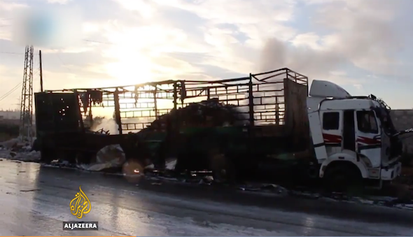 The charred remains of a vehicle in the convoy