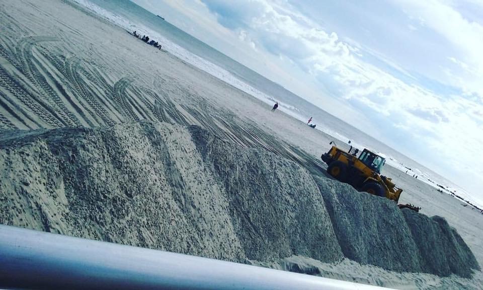 The city built temporary sand dunes along the beach as part of its storm preparation efforts