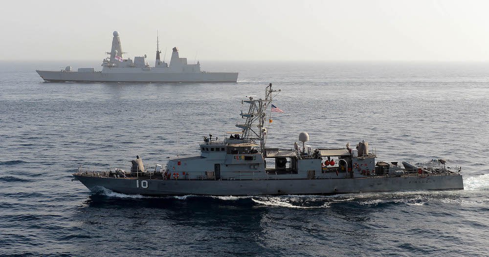 130521-O-ZZ999-101 U.S. 5th FLEET AREA OF RESPONSIBILITY The coastal patrol craft USS Firebolt and the Royal Navy destroyer HMS Dragon are underway together during International Mine Countermeasures Exercise 2013. IMC