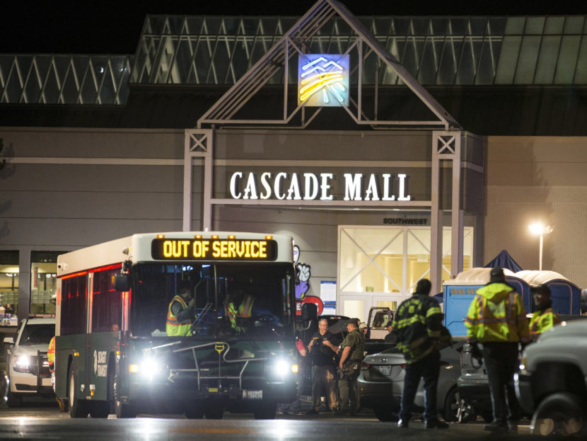 Emergency personnel stand in front of an entrance to the Cascade Mall at the scene of a shooting where five people were killed on Friday in Burlington Wash. Stephen Brashear  AP