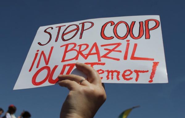 A demonstrator holds up a sign against Brazil's