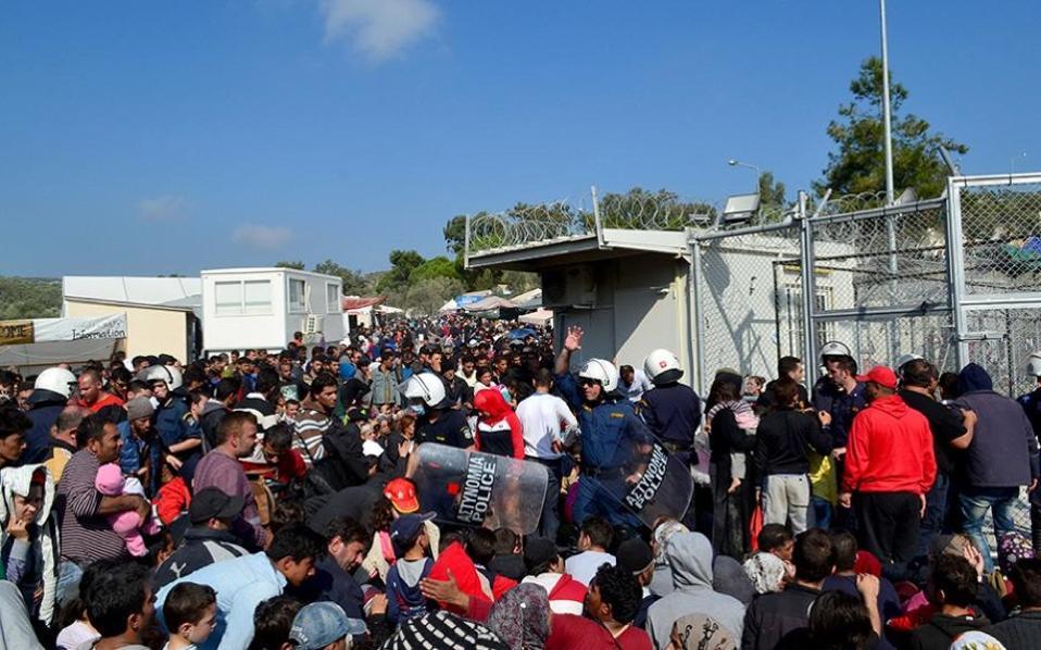 Thousands flee fire at migrant camp on Lesbos as scores try to dive on sinking lifeboats