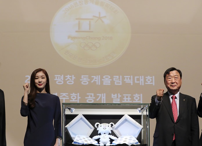 Former South Korean Olympic figure skating champion Yuna Kim left and Lee Hee-beom President of the Pyeongchang Organizing Committee for the 2018 Olympic and Paralympic Winter Games pose for the media during a press event in Seoul South Korea Thursd