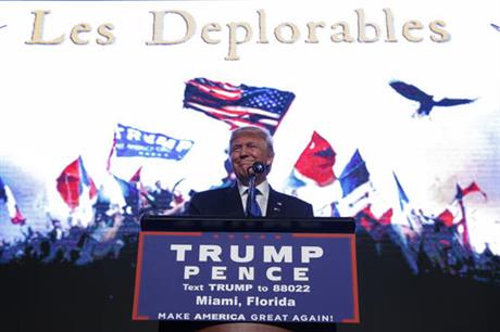 Republican presidential candidate Donald Trump smiles as he arrives to a campaign rally at the James L. Knight Center Friday Sept. 16 2016 in Miami