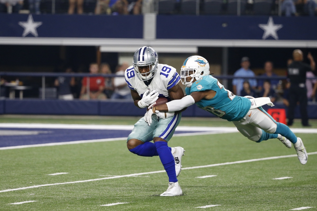 Dallas Cowboys wide receiver Brice Butler fights for extra yardage against Miami Dolphins cornerback Bobby Mc Cain after making a catch during an NFL preseason football game Friday Aug. 19 2016 in Arlington Texas. (AP