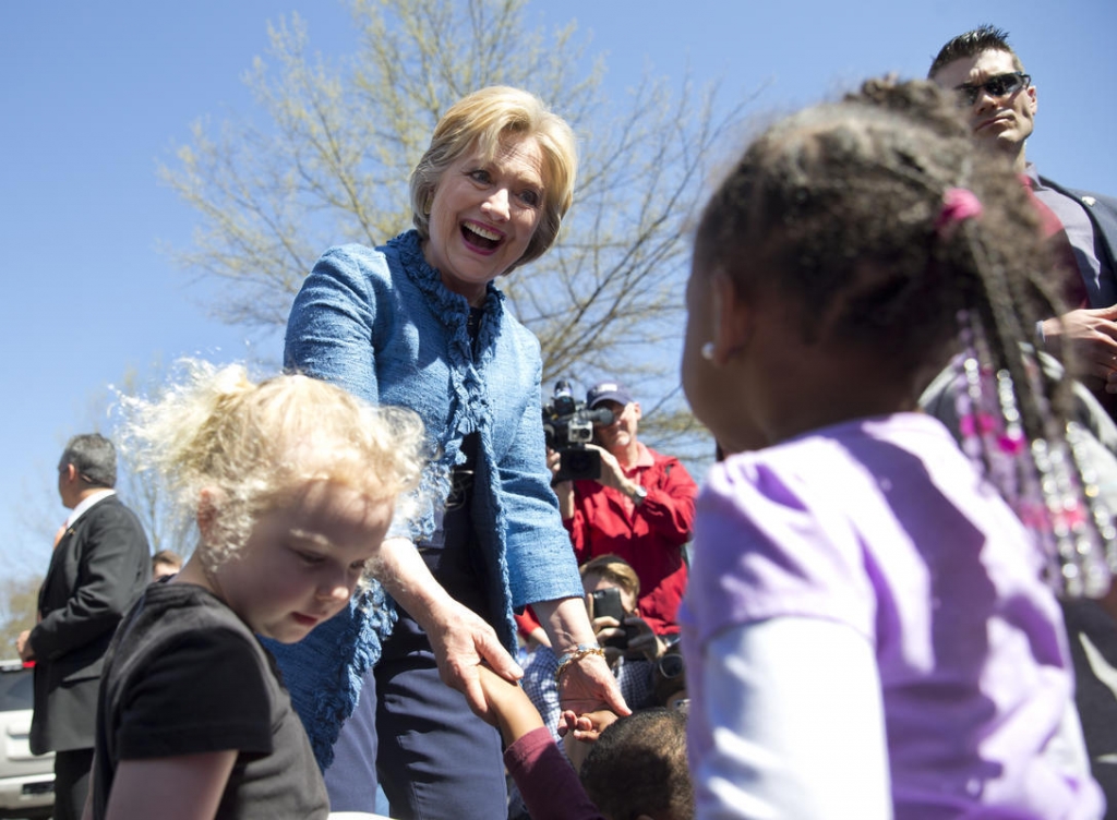 Democratic presidential candidate Hillary Clinton visits talks with a group of little kids as she visits a polling place a Southeast Raleigh Magnet High School in Raleigh N.C. Tuesday