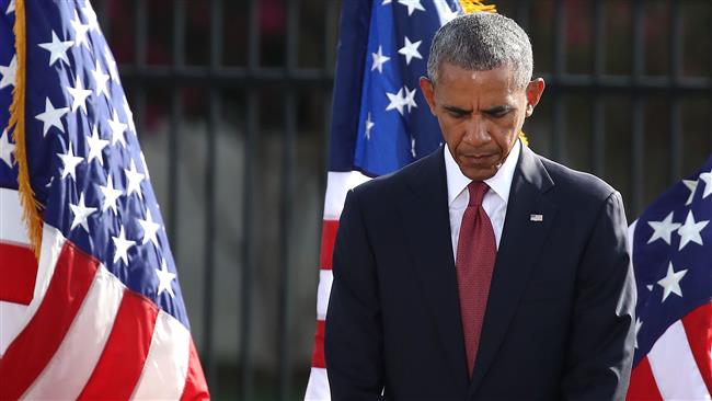 US President Barack Obama participates in a moment of silence during a ceremony to mark the 15th anniversary of the 9/11 attacks in front of the Pentagon in Arlington Virginia