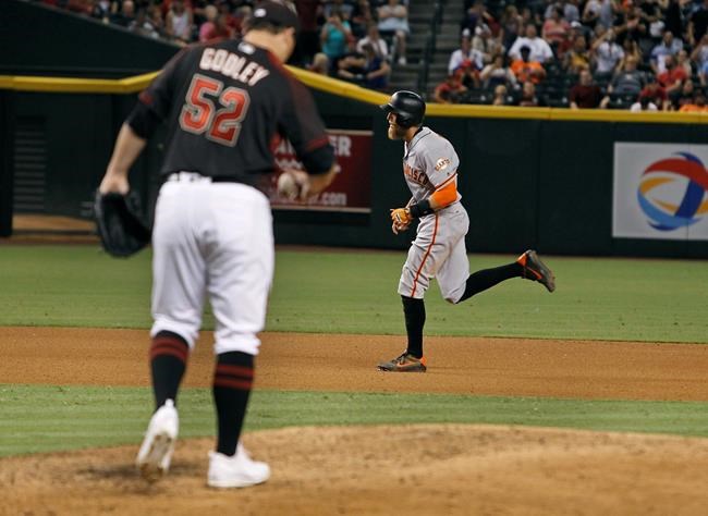 San Francisco Giants&#39 Hunter Pence right runs around the bases after hitting a solo home run as Arizona Diamondbacks pitcher Zack Godley kicks at the mound during the seventh inning of a baseball game Saturday Sept. 10 2016 in Phoenix. (AP Phot