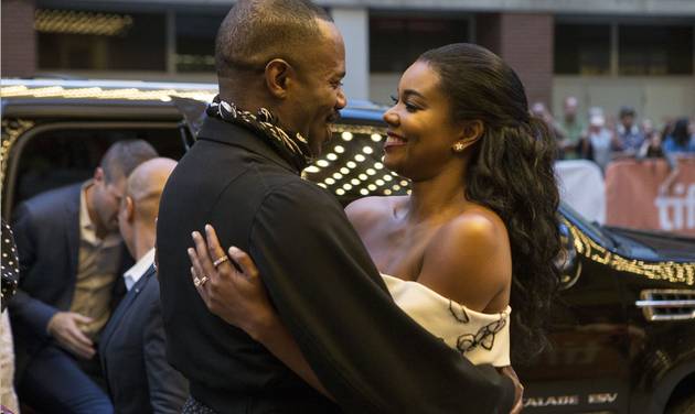 Colman Domingo left embraces fellow actor Gabrielle Union as they arrive on the red carpet for the film'Birth of a Nation during the 2016 Toronto International Film Festival in Toronto on Friday Sept. 9 2016