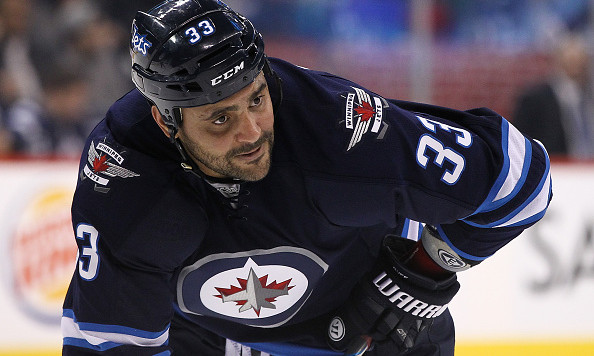 WINNIPEG MB- FEBRUARY 11 Dustin Byfuglien #33 of the Winnipeg Jets prepares for the faceoff in second period action in an NHL game against the Boston Bruins at the MTS Centre