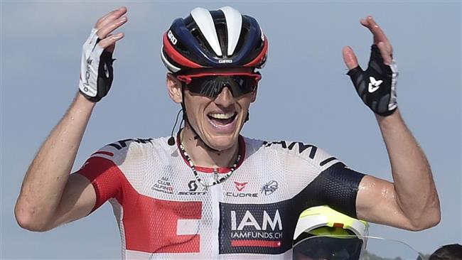 Iam's Swiss cyclist Mathias Frank celebrates winning as he crosses the finish line during the 17th stage of the 71st edition of'La Vuelta Tour of Spain a 173.3km route Castellon to Llucena