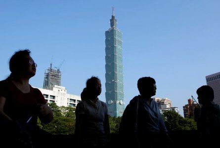 Tourists from China walk past the Taiwan's landmark building Taipei 101 in Taipei Taiwan