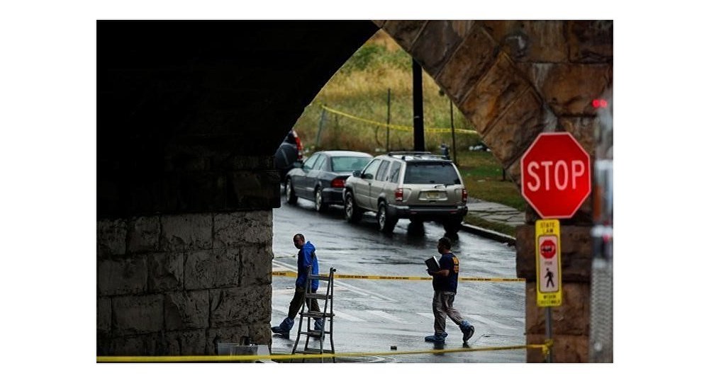 Federal Bureau of Investigation officials walk near the area where an explosive device left at a train station was detonated by the authorities in Elizabeth New Jersey U.S