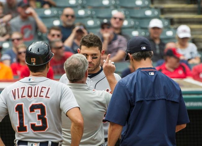 Detroit Tigers&#39 Ian Kinsler is checked by a trainer after being hit in the head by Cleveland Indians starting pitcher Trevor Bauer during the third inning of a baseball game in Cleveland Sunday Sept. 18 2016. Tigers coach Omar Vizquel and mana