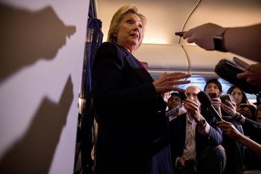 Democratic presidential candidate Hillary Clinton speaks to members of the media on board her campaign plane as she travels to Tampa. When Clinton met up with her brand new campaign plane she greeted crew members climbed