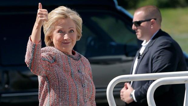 US Democratic presidential candidate Hillary Clinton gives a thumbs up as she boards her campaign plane to resume her