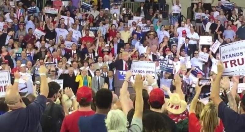 Supporters of Donald Trump pledge to vote for him during a rally in Orlando Florida