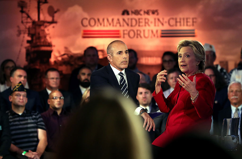 Matt Lauer looks on as Democratic presidential nominee Hillary Clinton speaks during the NBC News Commander-in Chief Forum