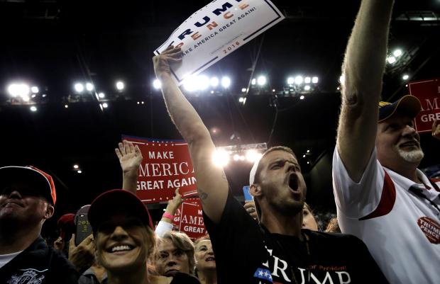 Trump supporters cheer as he speaks at a campaign rally in Florida