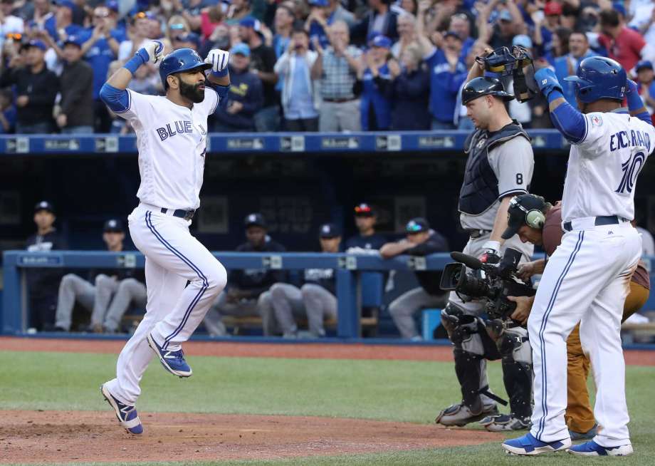 TORONTO CANADA- SEPTEMBER 24 Jose Bautista #19 of the Toronto Blue Jays celebrates his three-run home run with Edwin Encarnacion #10 in the eighth inning during MLB game action against the New York Yankees