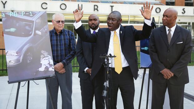 Attorney Benjamin Crump centre one of the attorneys for Crutcher's family says that Terence Crutcher's hands were