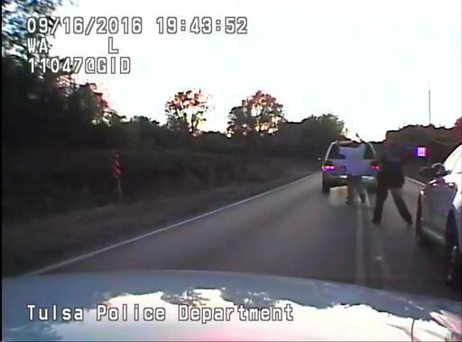 In this image made from a Friday Sept. 16 2016 police video Terence Crutcher left is pursued by police officers as he walks to an SUV in Tulsa Okla. Crutcher was fatally shot Friday after authorities say an officer stopped to investigate the stalled