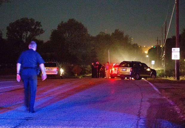 Police work the scene of a shooting late Friday Sept. 16 2016 in Tulsa Okla. A Tulsa police officer shot and killed a black man who ignored repeated requests to put up his hands before reaching into an SUV that was stalled in the middle of a street