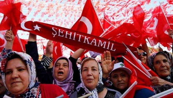 People wave national flags as they wait for President Tayyip Erdogan to arrive at the United Solidarity and Brotherhood rally in Gaziantep Turkey Aug. 28 2016