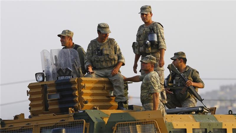 Turkish armoured personnel carriers drive towards the border in Karkamis on the Turkish Syrian border in the southeastern Gaziantep province Turkey