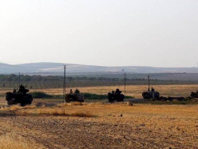 Turkish armoured personnel carriers drive towards the border in Karkamis on the Turkish Syrian border in the southeastern Gaziantep province Turkey