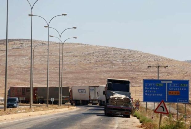 Commercial Turkish trucks wait to cross to Syria near the Cilvegozu border gate located opposite the Syrian commercial crossing point Bab al Hawa in Reyhanli Hatay province Turkey