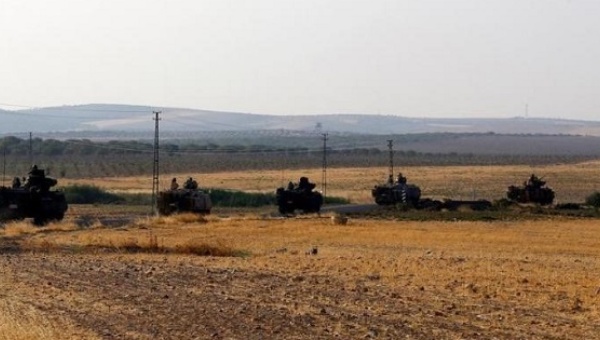 Turkish armoured carriers drive towards the border in Karkamis on the Turkish Syrian border in the southeastern Gaziantep province Turkey Aug. 27 2016