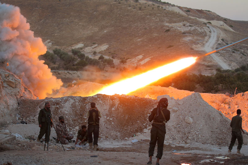 Free Syrian Army fighters launch a Grad rocket from Halfaya town in Hama province towards forces loyal to Syria's President Bashar al Assad stationed in Zein al Abidin mountain Syria