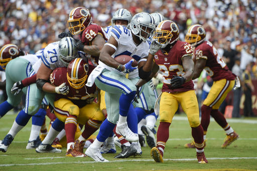 Dallas Cowboys linebacker Albert Morris carries the ball into the end zone for a touchdown past Washington Redskins free safety De Angelo Hall during the second half of an NFL football game in Landover Md. Sunday Sept