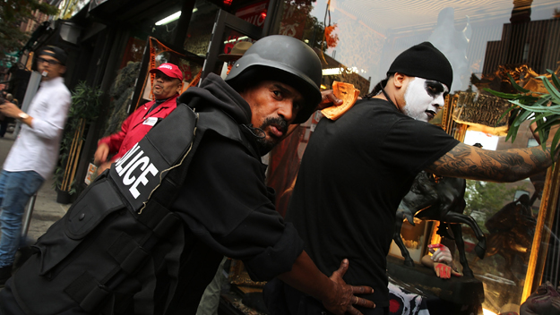 Two men reenact the controversial 'stop-and-frisk&#039 pose on a West Village street in New York City