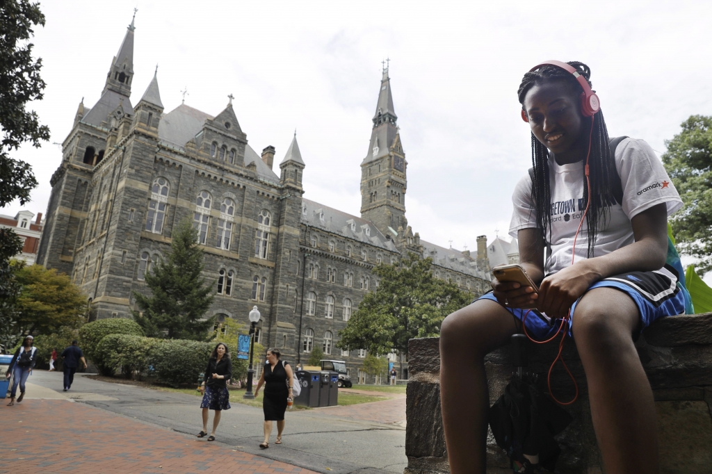 Deja Lindsey 20 a junior at Georgetown University talks on her cell phone in front of Healy Hall on campus Thursday Sept. 1 2016 in Washington