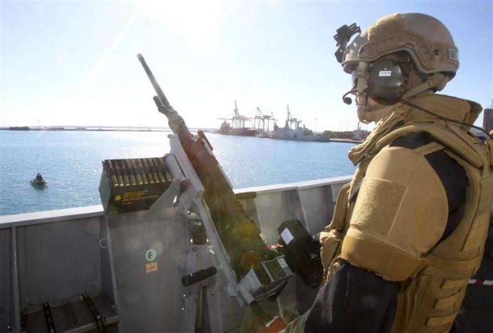 A member of the Norwegian Special Forces stands guard on a frigate which is part of a joint Norwegian Danish task force planning to assist in the transfer of lethal chemical weapons out of Syria at Limassol