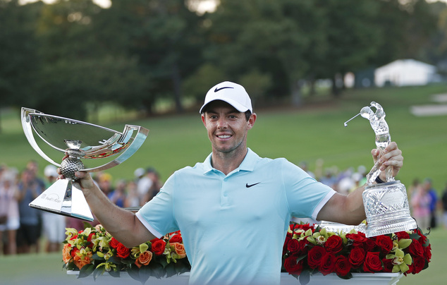 Rory Mc Ilroy poses with the trophies after winning the Tour Championship golf tournament and FedEX Cup at East Lake Golf Club Sunday Sept. 25 2016 in Atl